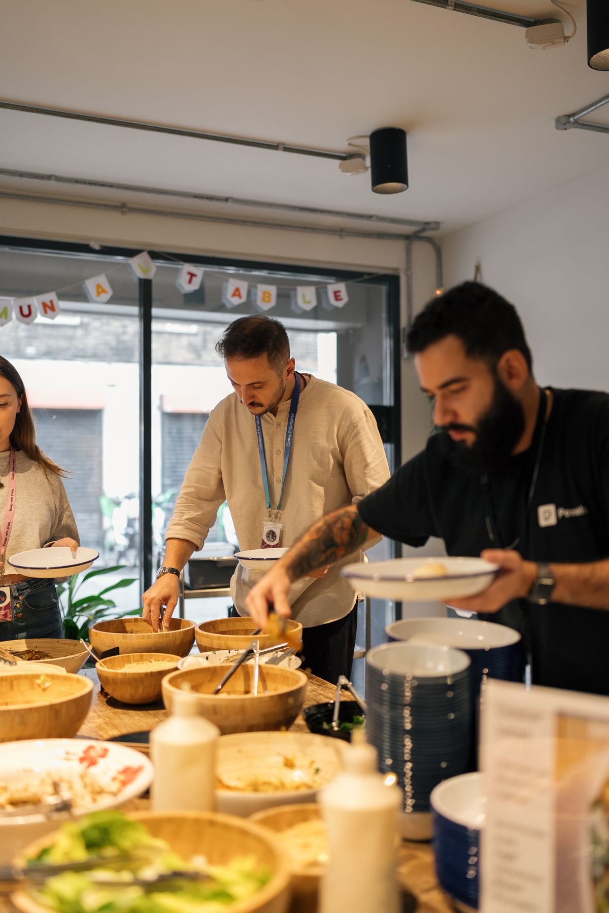 Office team serving themselves a healthy lunch of salads and bowls during a group meal at work